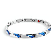 Bracelet magnétique en titane argenté avec accents bleus triangulaires pour homme.
