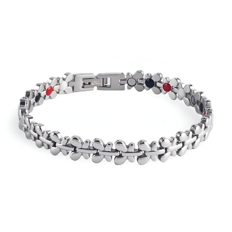 Bracelet magnétique Idunn en acier inoxydable argenté avec maillons arrondis et pastilles noires et rouges.