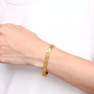 Bracelet magnétique homme en titane doré avec maillons élégants et finition brillante.