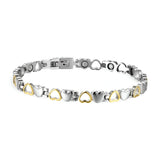 Bracelet magnétique en titane argenté avec cœurs dorés alternés et fermoir sécurisé.