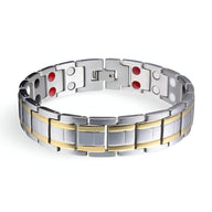 Bracelet magnétique homme en acier inoxydable argenté avec détails dorés et aimants rouges visibles.
