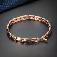 Bracelet magnétique pour femme en acier titane or rosé, maillons rectangulaires et fermoir sécurisé.