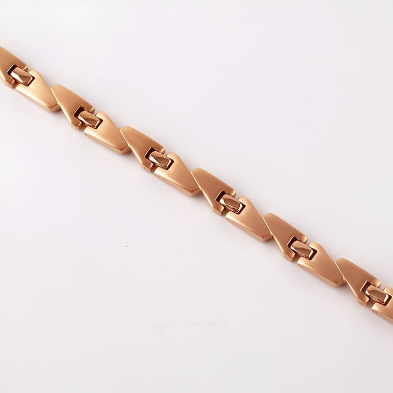 Bracelet magnétique en titane or rosé pour femme avec maillons géométriques élégants.