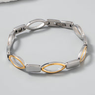 Bracelet magnétique femme en titane argenté et or avec maillons ovales alternés.