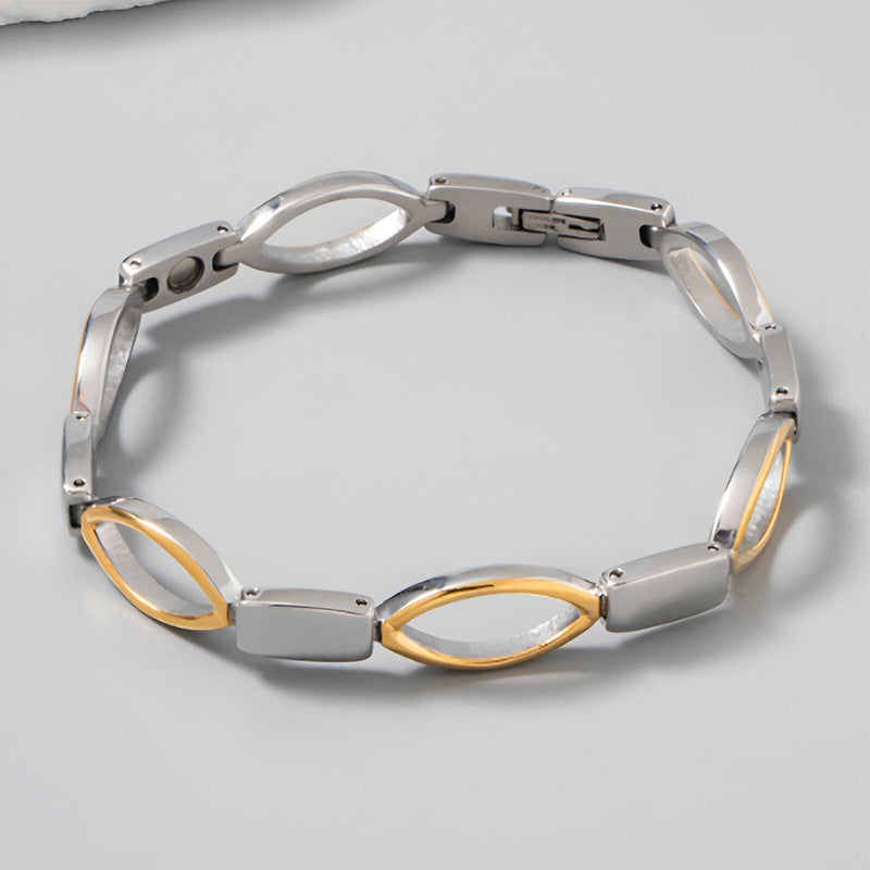 Bracelet magnétique femme en titane argenté et or avec maillons ovales alternés.