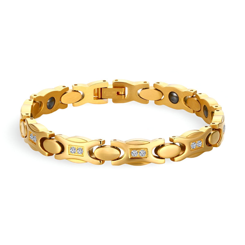 Bracelet magnétique en titane doré pour femme avec maillons ovales et incrustations de cristaux blancs.