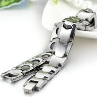 Bracelet magnétique en titane argenté pour homme au design moderne et maillons larges lisses.