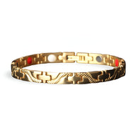 Bracelet magnétique fin en titane doré avec motifs gravés, intérieur à pastilles rouges et blanches.