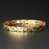 Bracelet magnétique fin en titane doré avec maillons ornés et détails colorés rouge, blanc, bleu.