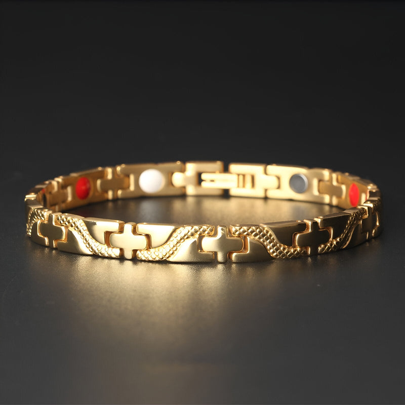 Bracelet magnétique fin en titane doré avec maillons ornés et détails colorés rouge, blanc, bleu.