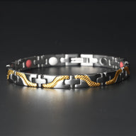 Bracelet magnétique fin en titane noir avec détails torsadés dorés et aimants rouges et blancs.