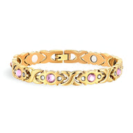 Bracelet magnétique en titane or serti de zirconium rose, design élégant pour femme.