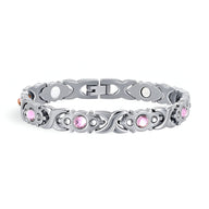 Bracelet magnétique en titane argenté orné de zirconiums roses ronds pour femme.