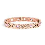 Bracelet magnétique en titane or rosé avec zirconiums roses sertis, style délicat pour femme.