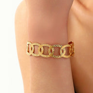 Bracelet manchette doré, ovales entrelacés, en acier inoxydable, modèle Astraïa - La Boutique du Bracelet