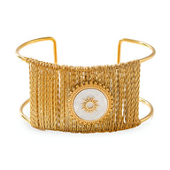 Bracelet manchette doré tissé avec pierre blanche ornée d'un motif soleil central.