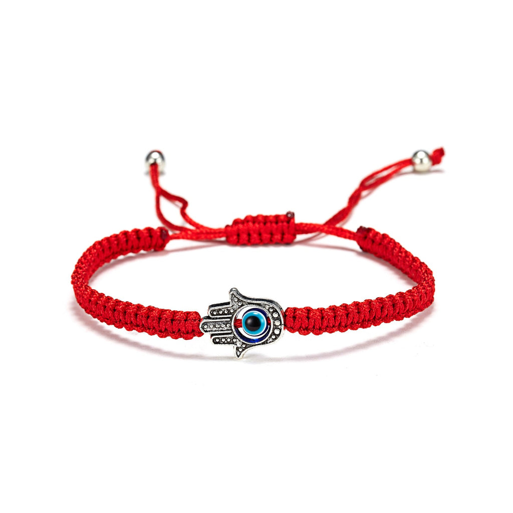 Bracelet en fil rouge ciré avec main de Fatma argentée détaillée et œil bleu central ajustable.