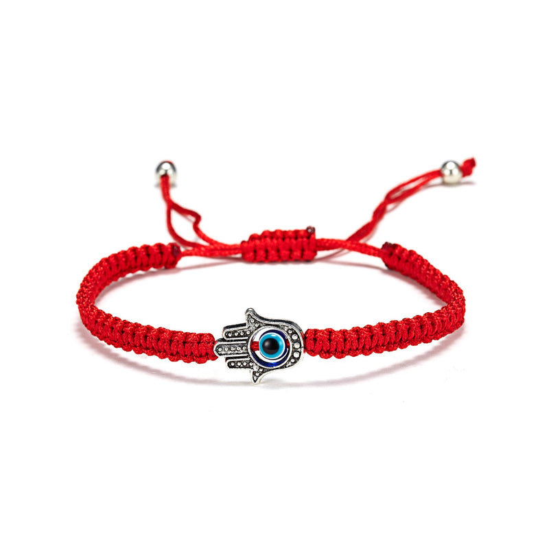 Bracelet en fil rouge ciré avec main de Fatma argentée détaillée et œil bleu central ajustable.
