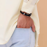 Bracelet homme noir en coton avec mousqueton en acier inoxydable porté au poignet.