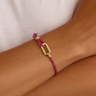 Bracelet ajustable en nylon rose vif avec mousqueton doré en acier inoxydable.