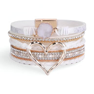 Bracelet multi-rangs blanc avec grand cœur doré et pierres brillantes en strass.