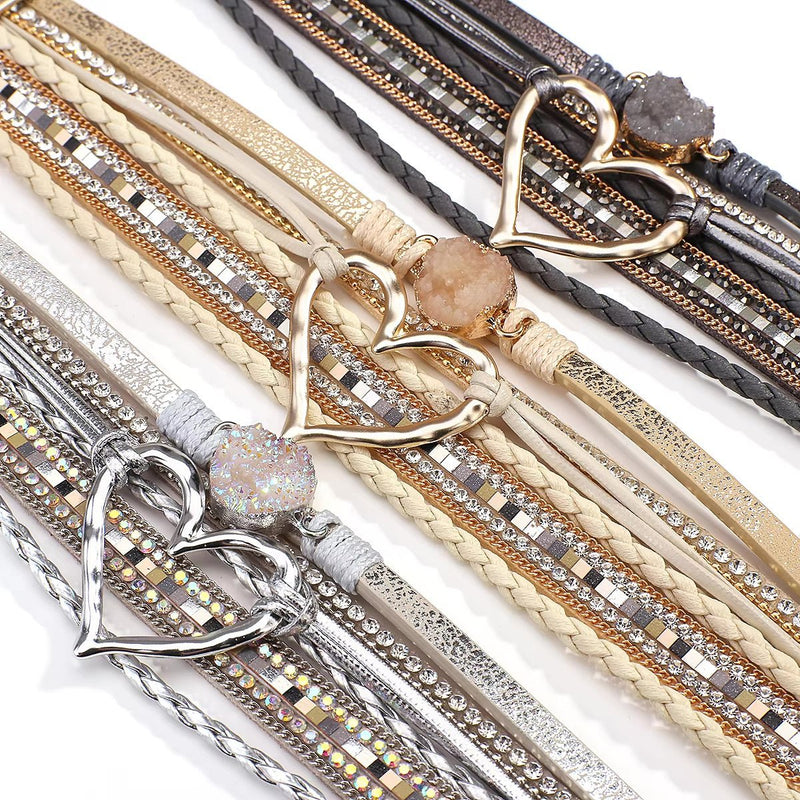 Bracelet multi-rangs beige avec cœur central doré et pierre centrale beige scintillante.