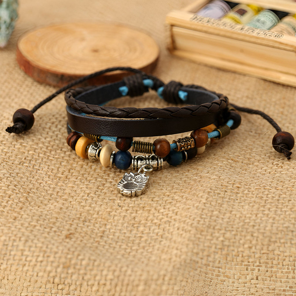 Bracelet multi-rangs en cuir marron avec perles bois et métal, charm hibou argenté, style mixte.