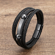 Bracelet homme multi-rangs noir en microfibre avec détails métalliques brillants et fermoir magnétique.