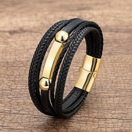 Bracelet homme multi-rangs noir en microfibre avec détails dorés et fermeture magnétique.
