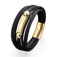 Bracelet multi-rangs noir en microfibre avec plaque et détails métalliques dorés, fermoir magnétique.