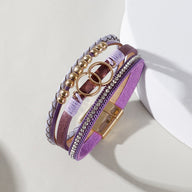 Bracelet multi-rangs violet en simili cuir avec strass, anneaux dorés décoratifs et fermoir magnétique doré chic.