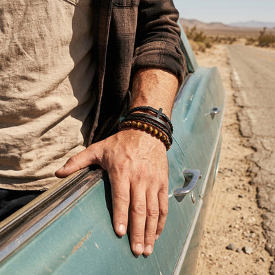 Men’s multi-wrap bracelet in black leather and natural tiger’s eye stone, masculine jewelry with stainless steel cross, Isorme model