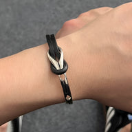 Bracelet homme noir en cuir tressé avec nœud et détail métallique en titane argenté.