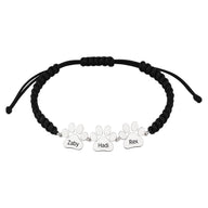 Bracelet en nylon noir ajustable avec trois pendentifs patte en acier inoxydable gravés Zaby, Hadi, Rex.