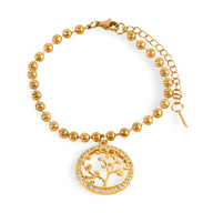 Bracelet or en titane perlé avec pendentif arbre de vie cerclé de cristaux éclatants.