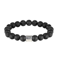 Bracelet élastique en perles de pierre de lave noires avec un cylindre argenté gravé de symboles astrologiques.