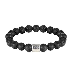Bracelet élastique en perles de pierre de lave noires avec un cylindre argenté gravé de symboles astrologiques.