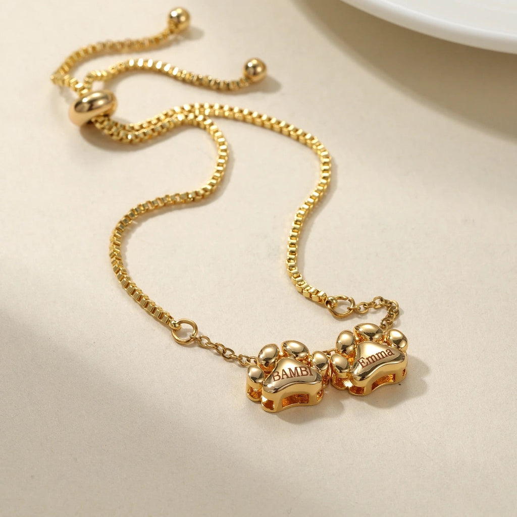 Bracelet or fin en acier inoxydable avec pendentifs personnalisés en forme de patte, ajustable et mixte.
