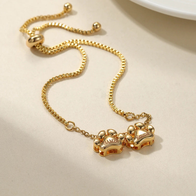 Bracelet or fin en acier inoxydable avec pendentifs personnalisés en forme de patte, ajustable et mixte.