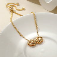 Bracelet personnalisé en acier inoxydable or avec pendentifs 2 pattes style Bambi réglable.