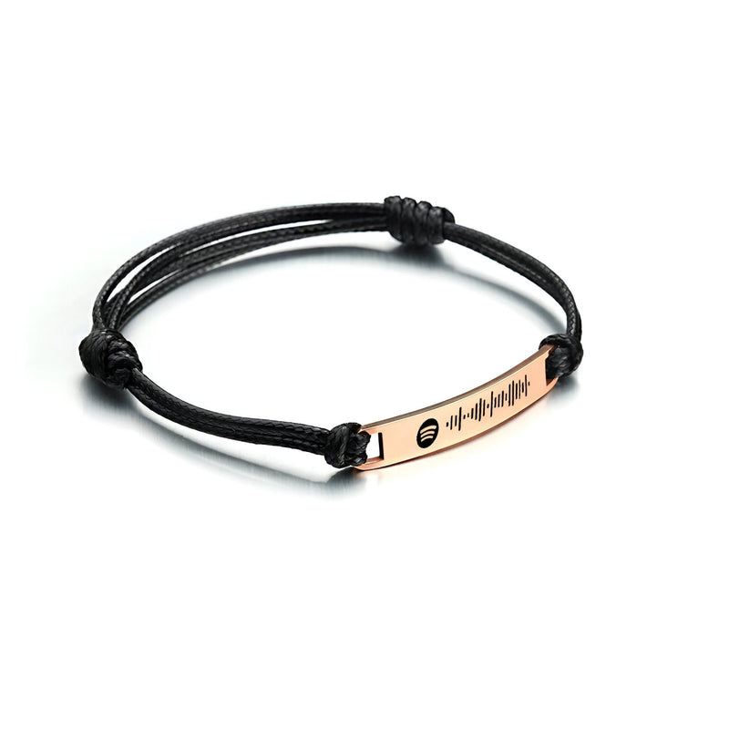 Bracelet corde noir avec plaque en acier inoxydable or rosé gravée d'ondes sonores.