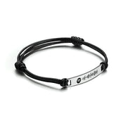 Bracelet corde noir avec plaque acier inoxydable gravée motif onde sonore et logo Spotify.