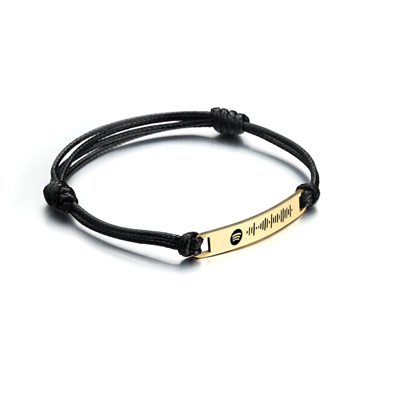 Bracelet en corde noire avec plaque en acier inoxydable doré gravée d'un motif Spotify personnalisé.