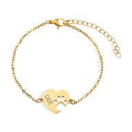 Bracelet en titane or avec cœur percé et empreinte de patte, chaîne fine réglable.