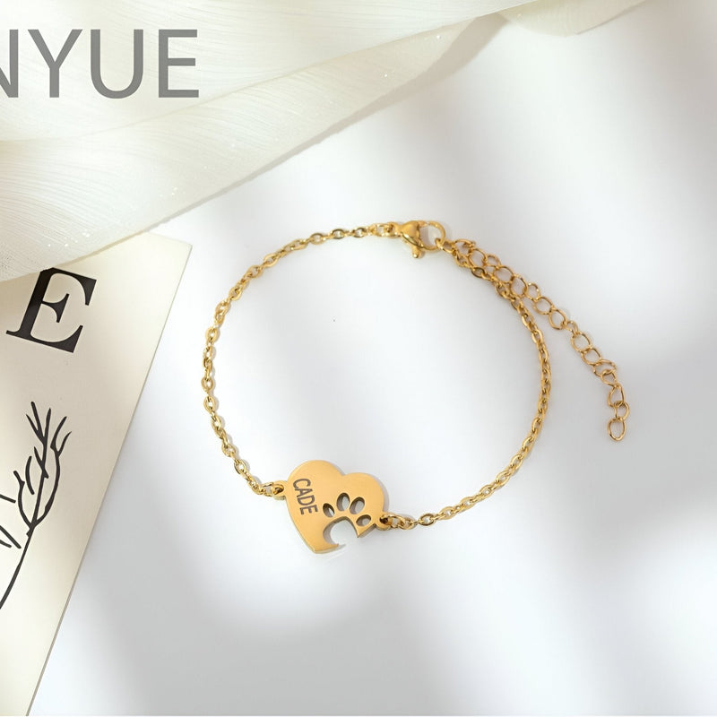Bracelet en titane doré avec pendentif cœur et empreinte de patte gravée "LOVE".