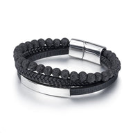 Bracelet homme avec perles noires volcaniques, cuir tressé noir et fermoir magnétique argenté.
