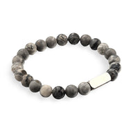 Bracelet mixte en perles rondes de jaspe gris avec plaque métallique argentée gravée.