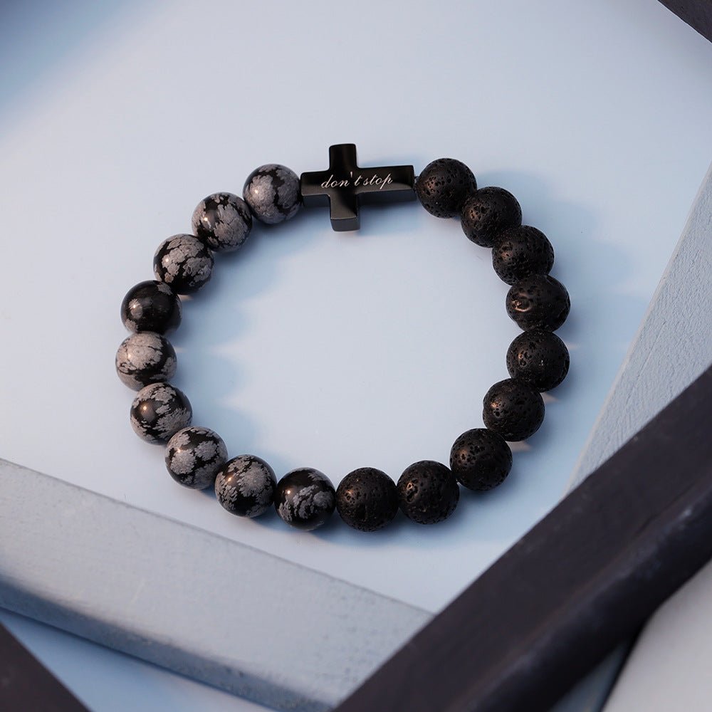 Bracelet homme perles pierre volcanique noires et turquoise noire marbrée avec croix noire gravée centrale.