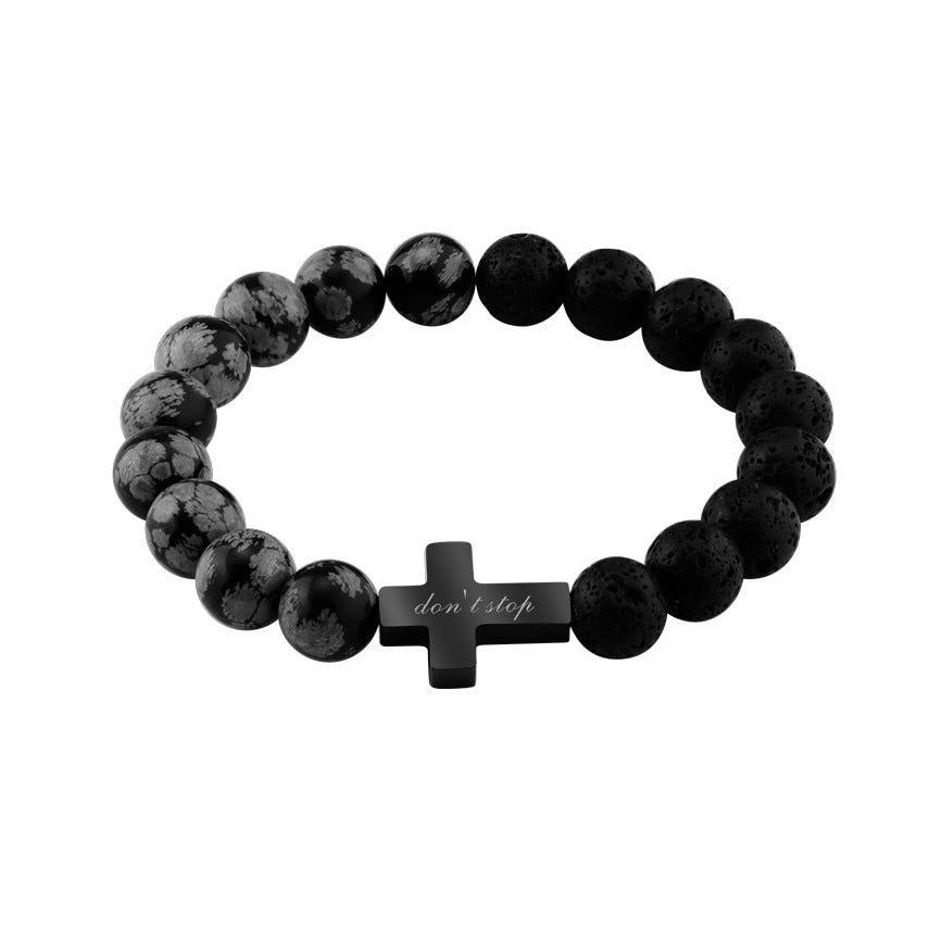 Bracelet homme perles noires et grises en pierre volcanique avec croix noire gravée centrale.