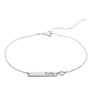 Bracelet fin en acier inoxydable avec plaque gravée "Buddy" et pendentif patte d'animal argenté.